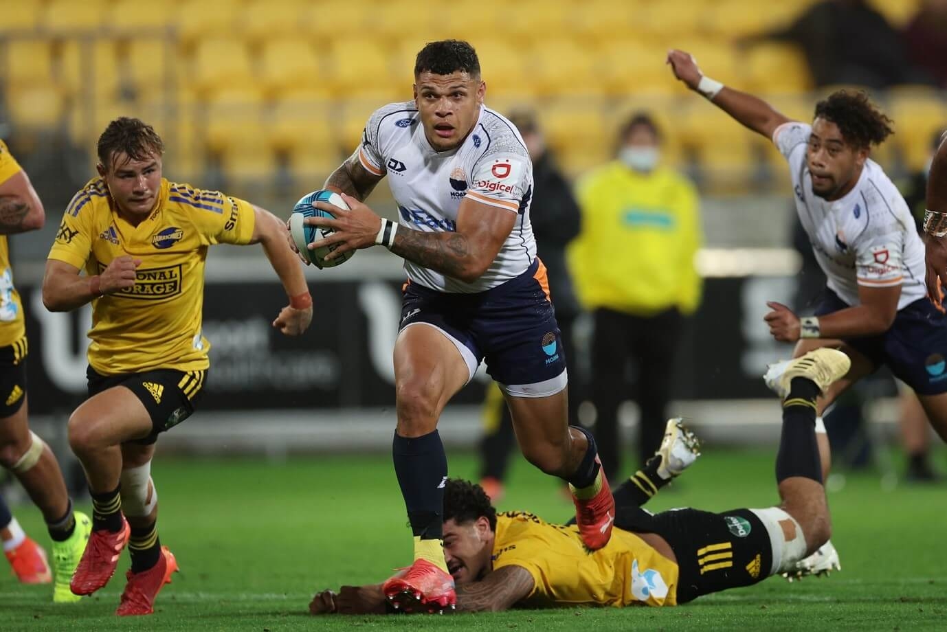 A Moana Pasifika Rugby player running with the ball