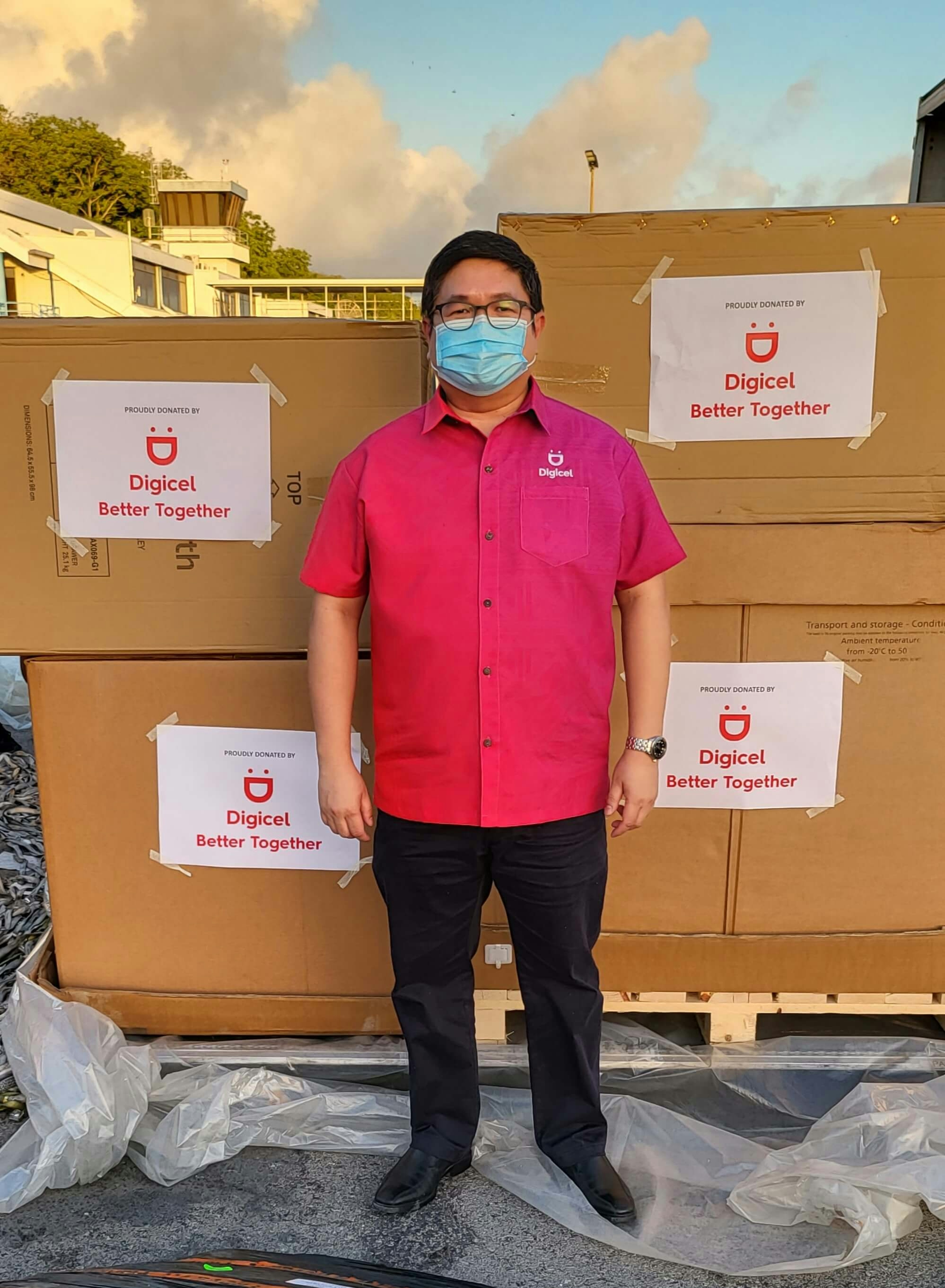 Christopher Manaog, Digicel Nauru CEO, standing in front of donated boxes