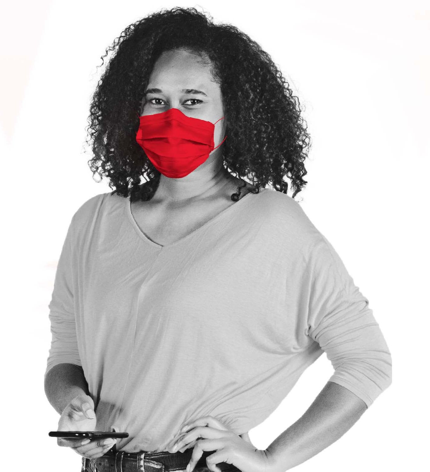 A woman holding a phone, wearing a red face mask