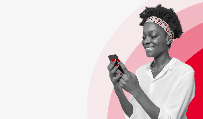 A woman smiling at her phone